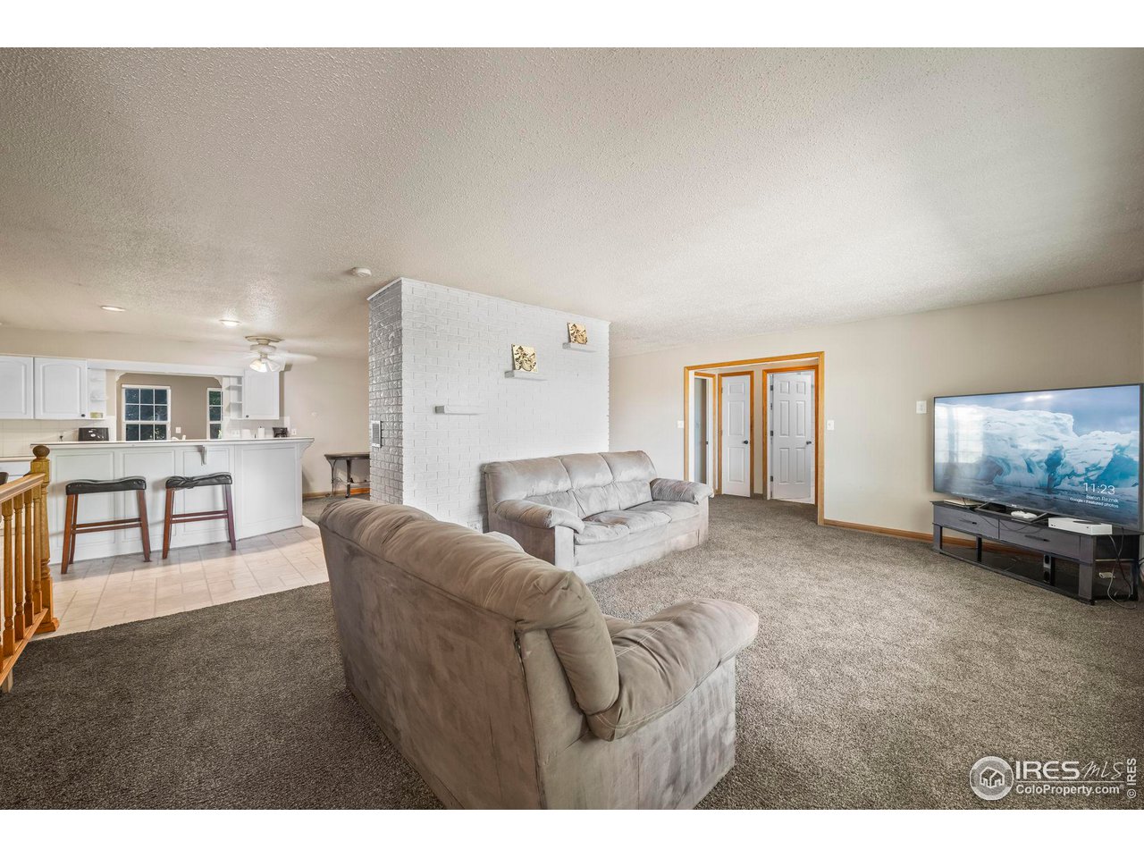 32864 County Road 49 Greeley, CO 80631 - Photo 6 of 40 a living room with furniture and a flat screen tv
