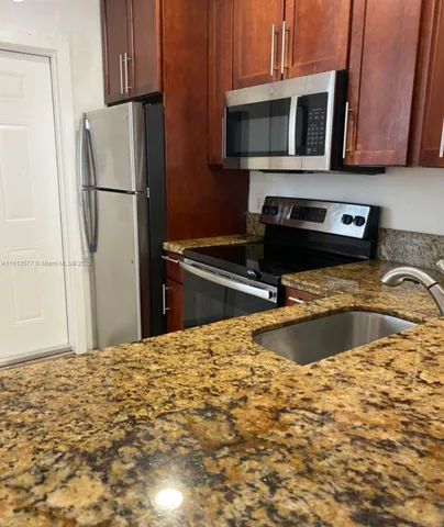 a kitchen with a refrigerator stove and microwave