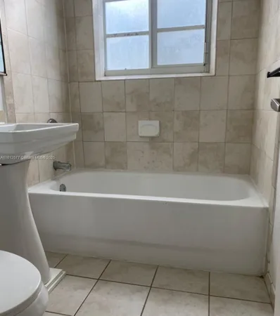 a white bath tub sitting next to a white toilet