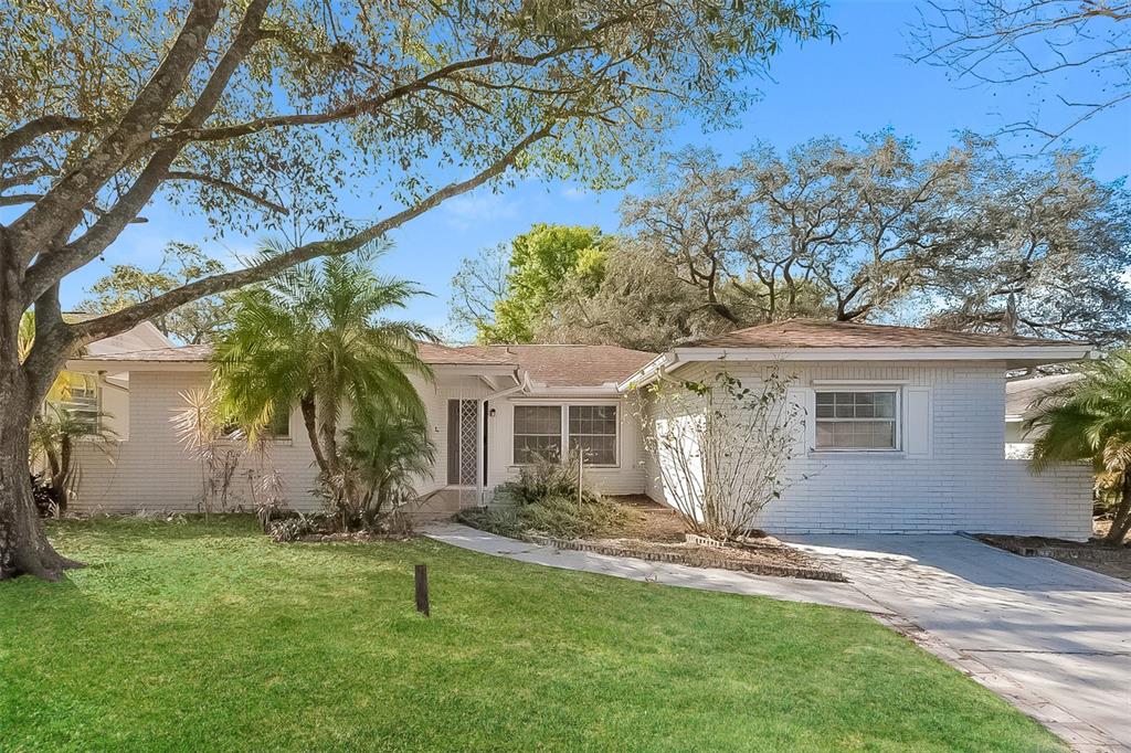 203 Valley Drive Brandon, FL 33510 - Photo 1 of 1 a front view of house with yard and trees in the background