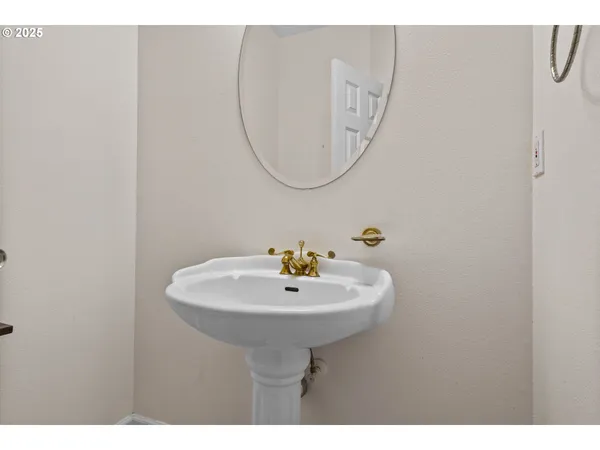 a bathroom with a sink a mirror and a light fixture