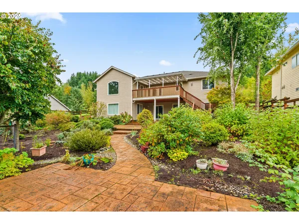 a front view of a house with a yard and a garden