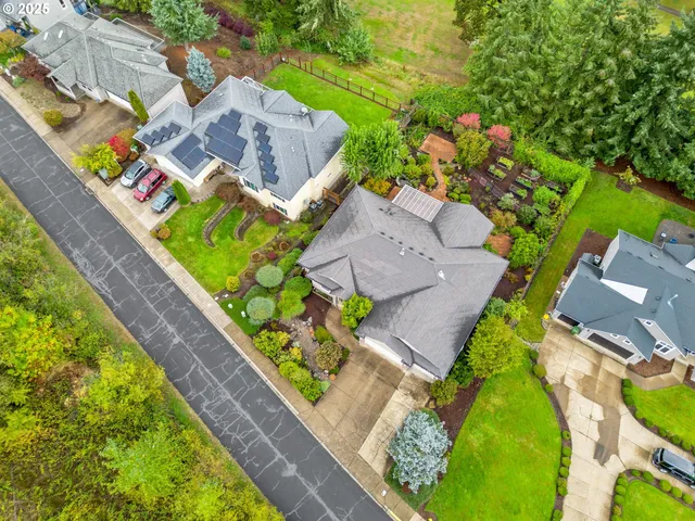 an aerial view of a house with a garden and swimming pool