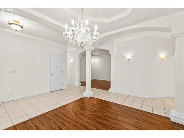 a view of an empty room and wooden floor