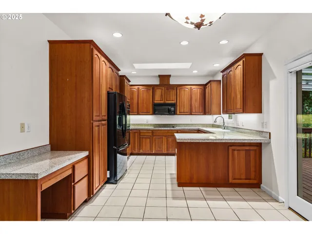 a kitchen with stainless steel appliances granite countertop a refrigerator and a sink