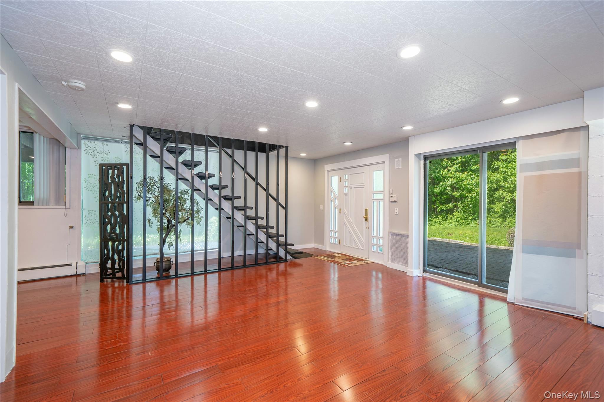 4 Half Mile Road Armonk, NY 10504 - Photo 22 of 28 Generous above-grade lower level with full bath, high ceilings, oversized windows, a beautiful fireplace, and massive storage space not shown. Perfect for guests, extended family, or in-law living.