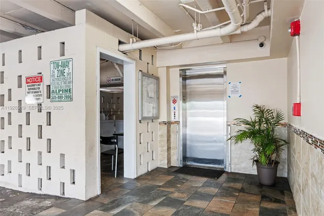a view of elevator with potted plants in front of door