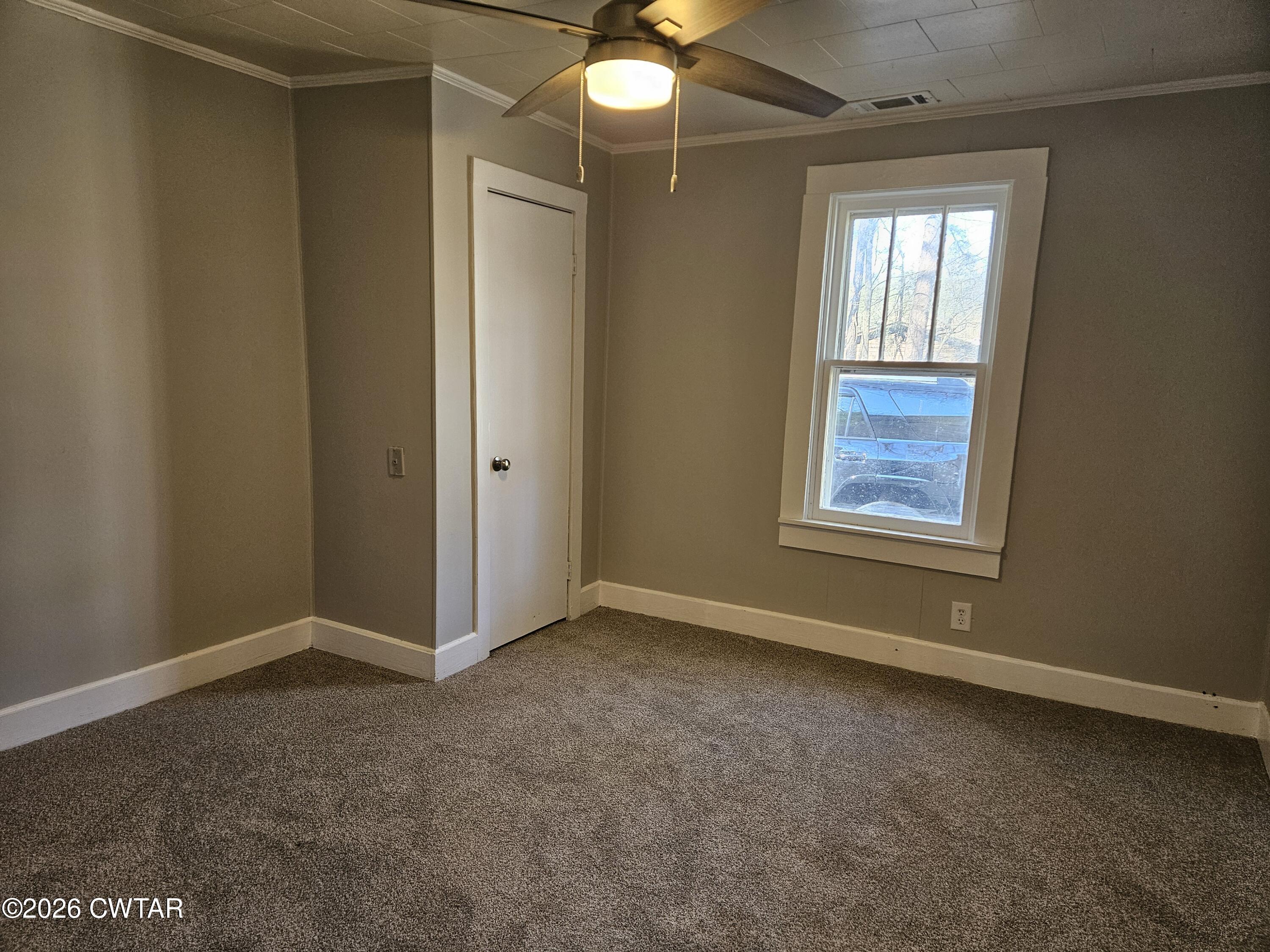 550 Lawrence Switch Road Jackson, TN 38305 - Photo 16 of 25 an empty room with windows and fan