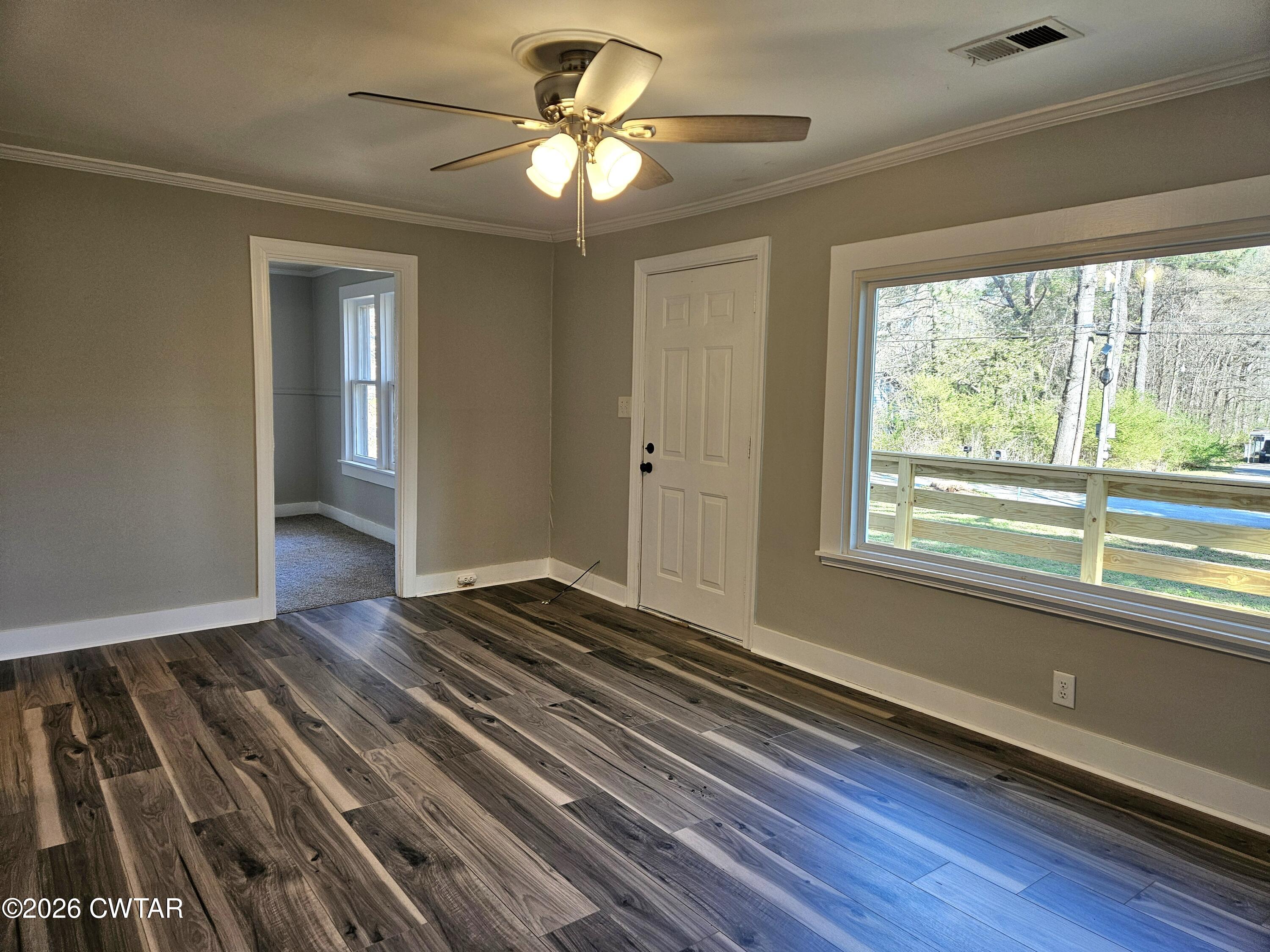 550 Lawrence Switch Road Jackson, TN 38305 - Photo 2 of 25 a view of an empty room with wooden floor and a window