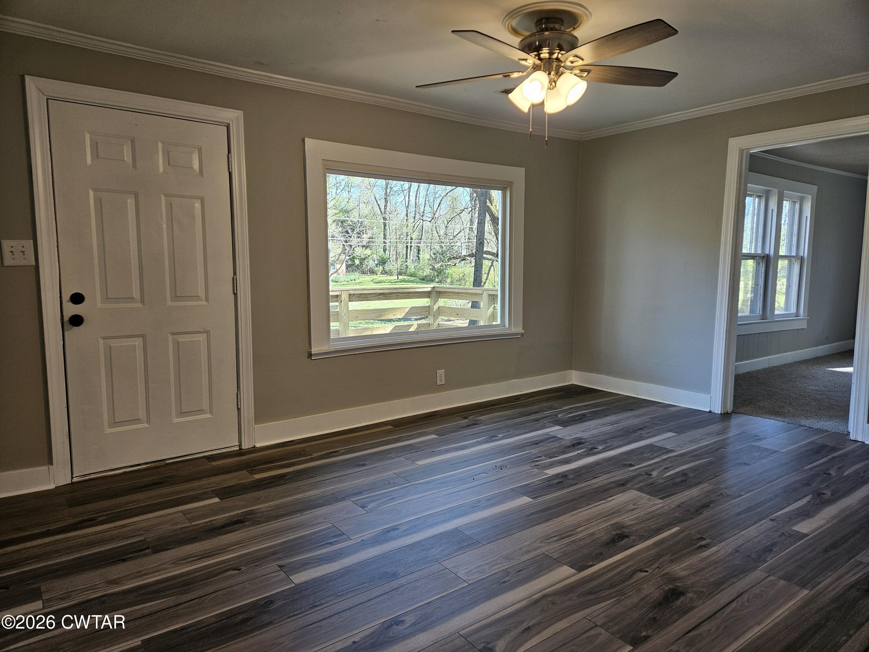 550 Lawrence Switch Road Jackson, TN 38305 - Photo 3 of 25 a view of empty room with wooden floor and fan