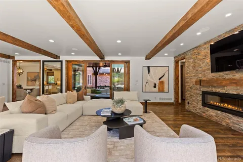 a view of a hardwood & hallway with a chandelier