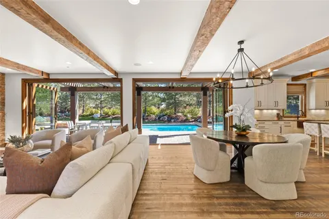 a dining room with furniture wooden floor a rug and a painting