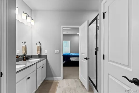 a bathroom with a double vanity sink and mirror