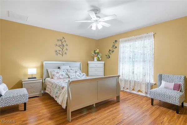 a living room with a bed furniture and a window