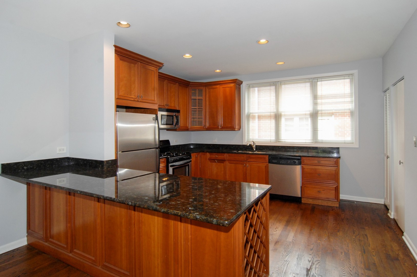 1765 West Altgeld Street, Unit M Chicago, IL 60614 - Photo 11 of 21 a kitchen with granite countertop a sink and a refrigerator