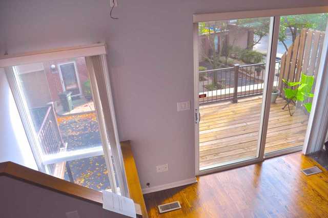 1765 West Altgeld Street, Unit M Chicago, IL 60614 - Photo 13 of 21 a view of empty room with wooden floor and floor to ceiling window