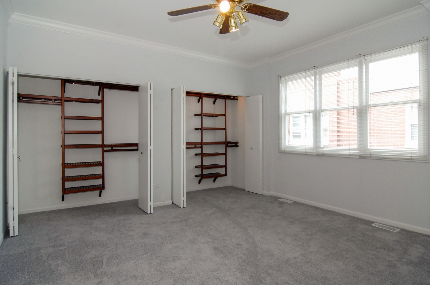 1765 West Altgeld Street, Unit M Chicago, IL 60614 - Photo 15 of 21 an empty room with windows closet and chandelier fan