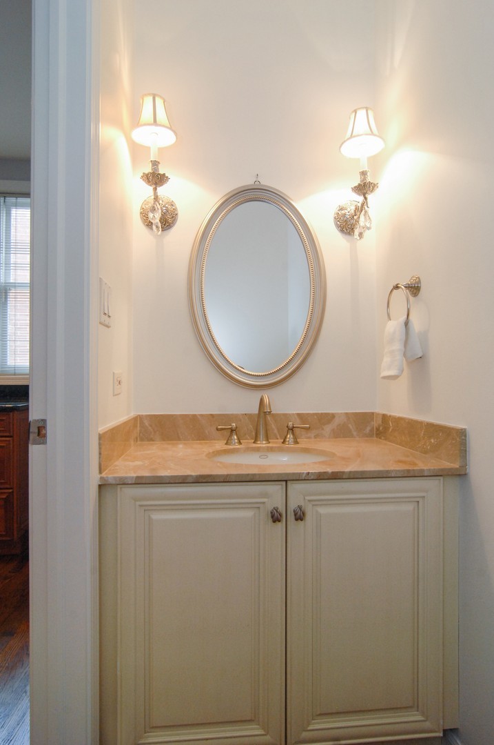 1765 West Altgeld Street, Unit M Chicago, IL 60614 - Photo 18 of 21 a bathroom with a granite countertop sink a mirror and vanity
