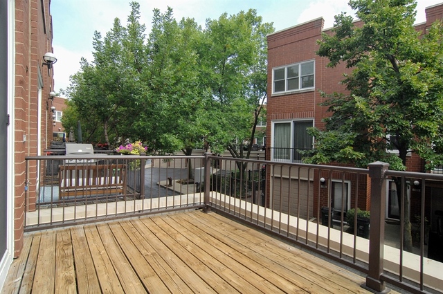 1765 West Altgeld Street, Unit M Chicago, IL 60614 - Photo 19 of 21 a view of deck with wooden floor and fence