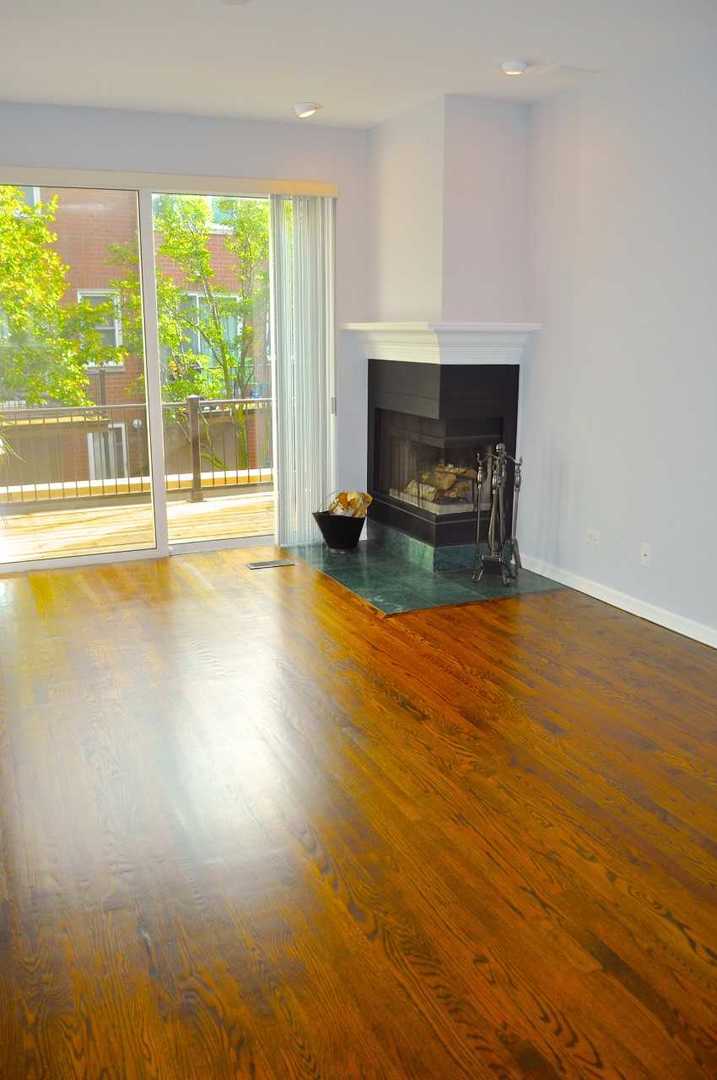 1765 West Altgeld Street, Unit M Chicago, IL 60614 - Photo 7 of 21 a view of empty room with wooden floor and fireplace