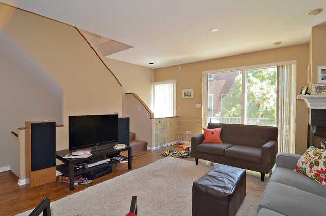 1765 West Altgeld Street, Unit M Chicago, IL 60614 - Photo 8 of 21 a living room with furniture and a flat screen tv