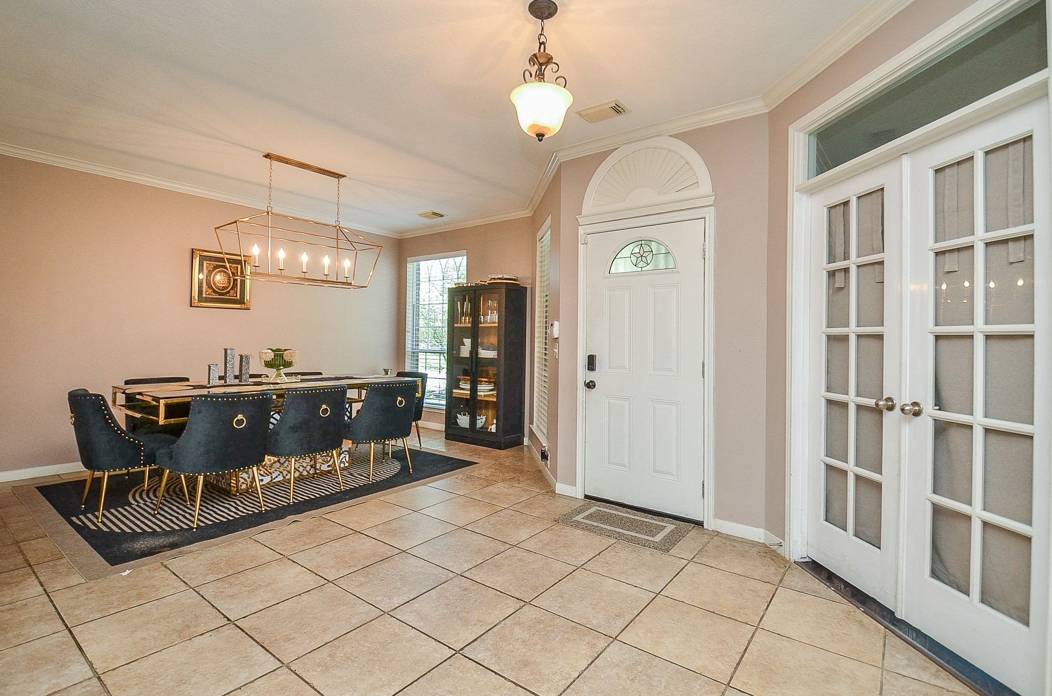 19802 Shavon Springs Drive Spring, TX 77388 - Photo 11 of 30 Elegant dining area featuring stylish lighting, ample seating, and natural light, perfect for hosting memorable gatherings.