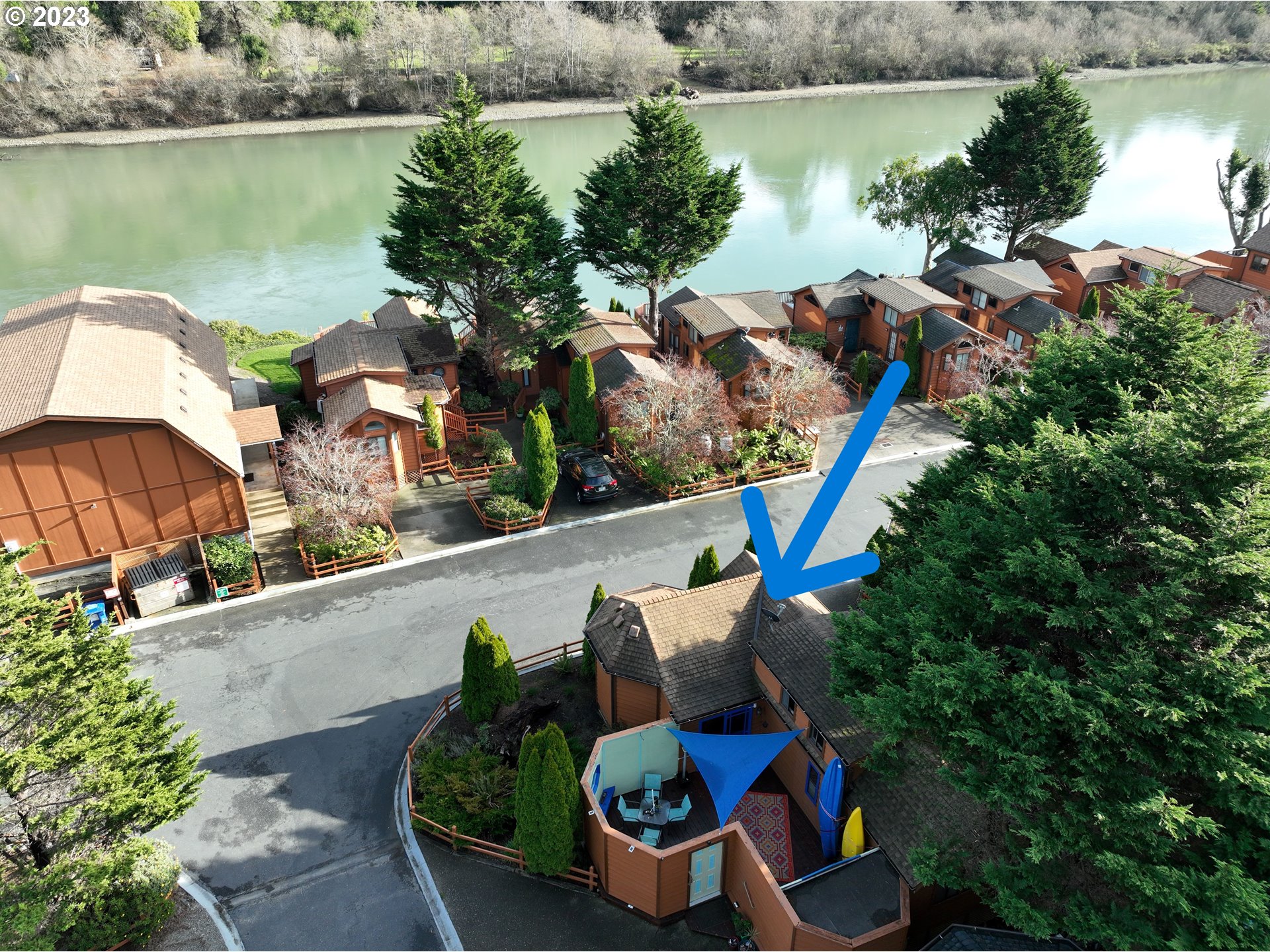 97748 North Bank Chetco River Road, Unit 15 Brookings, OR 97415 - Photo 2 of 48 a backyard of a house with wooden floor and outdoor seating