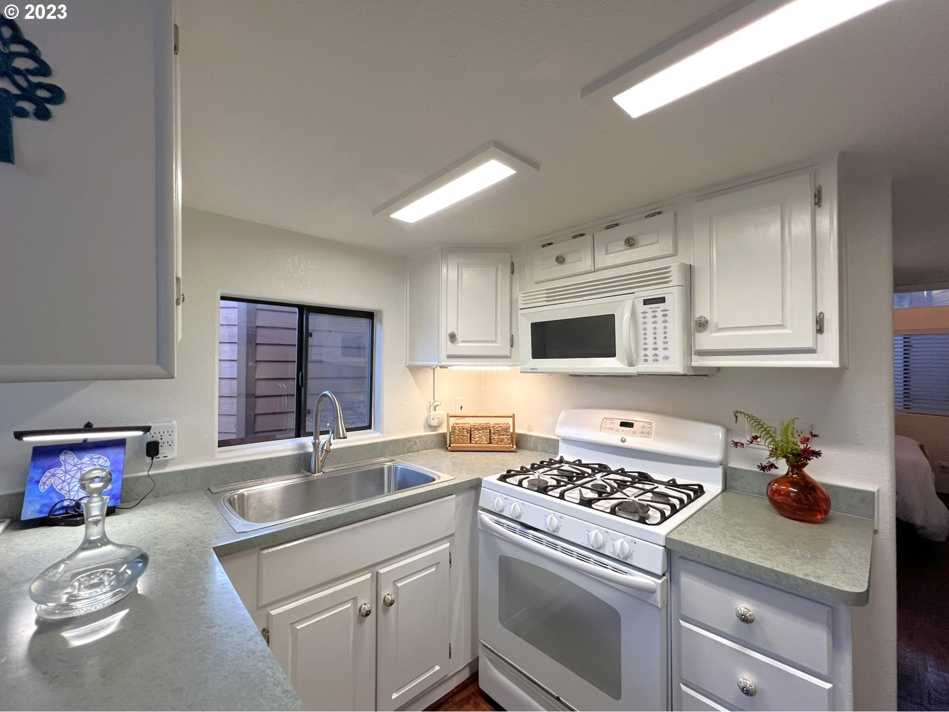 97748 North Bank Chetco River Road, Unit 15 Brookings, OR 97415 - Photo 33 of 48 a kitchen that has a sink and a stove in it