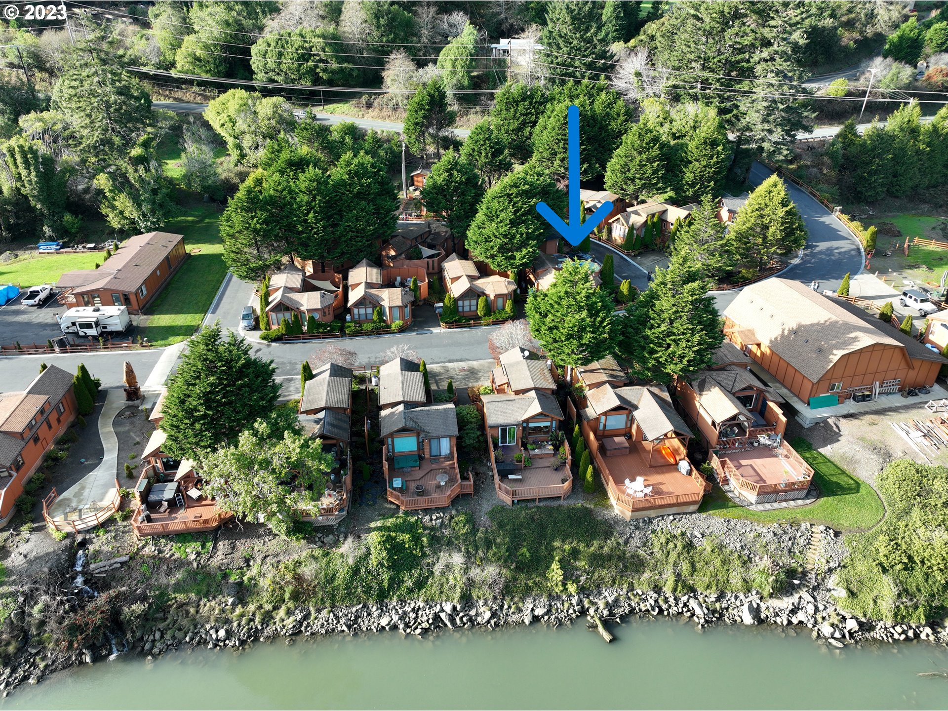 97748 North Bank Chetco River Road, Unit 15 Brookings, OR 97415 - Photo 5 of 48 an aerial view of a house with a yard basket ball court and outdoor seating