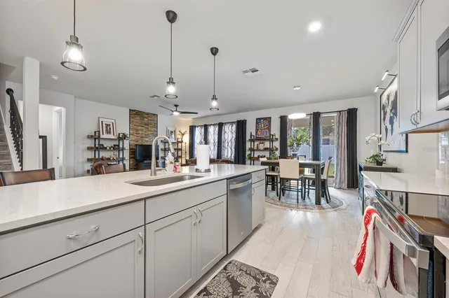 a kitchen with stainless steel appliances granite countertop a stove a sink and a microwave