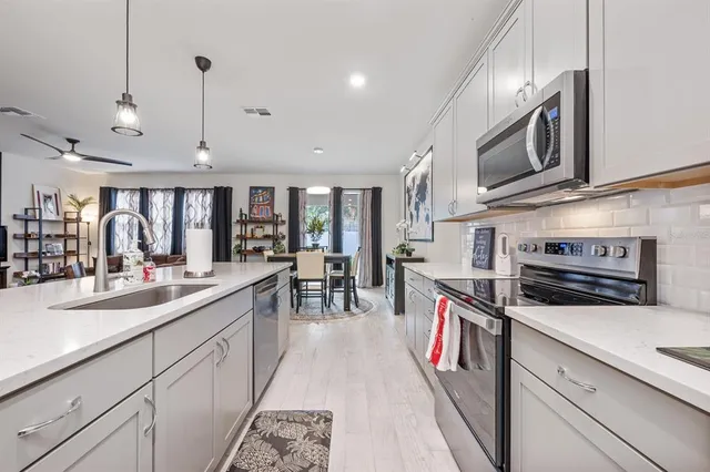 a kitchen with a sink appliances and a counter top space