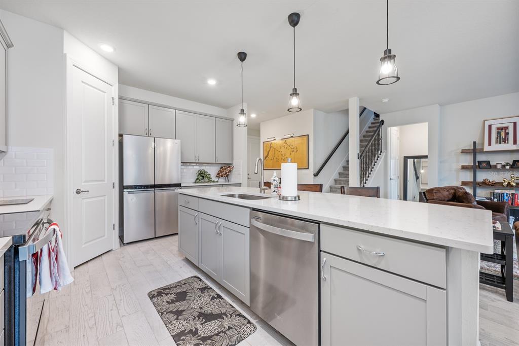 2713 Hilltop Loop Apopka, FL 32712 - Photo 15 of 54 a kitchen with a sink appliances and a counter top space
