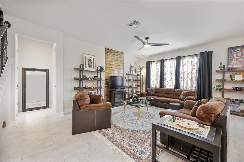 2713 Hilltop Loop Apopka, FL 32712 - Photo 19 of 54 a living room with furniture and a flat screen tv