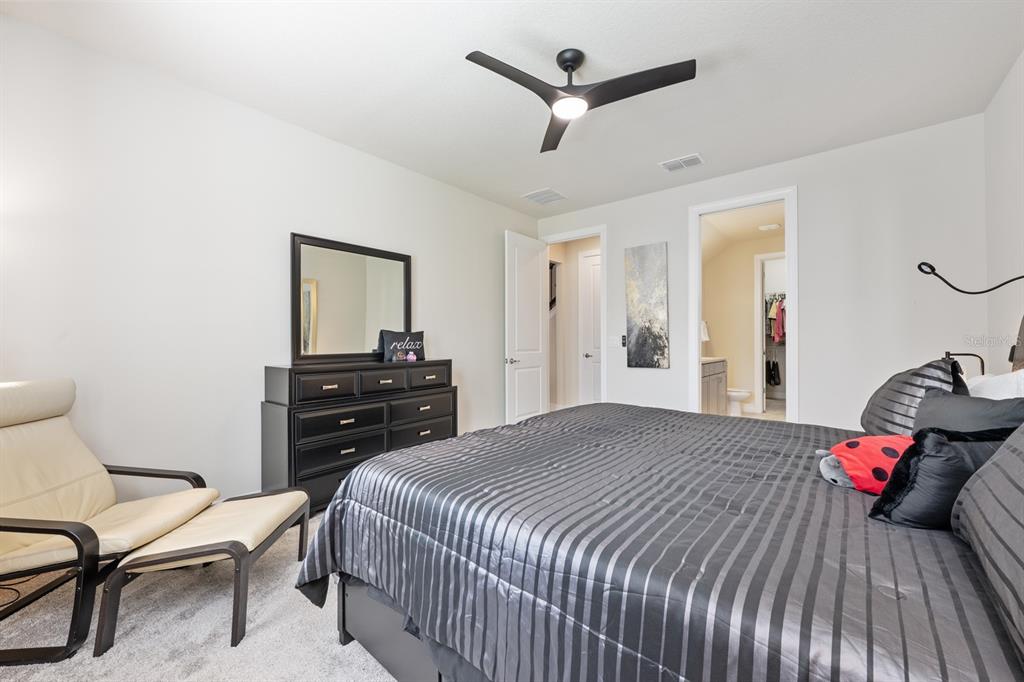 2713 Hilltop Loop Apopka, FL 32712 - Photo 24 of 54 a bedroom with a bed and a chair