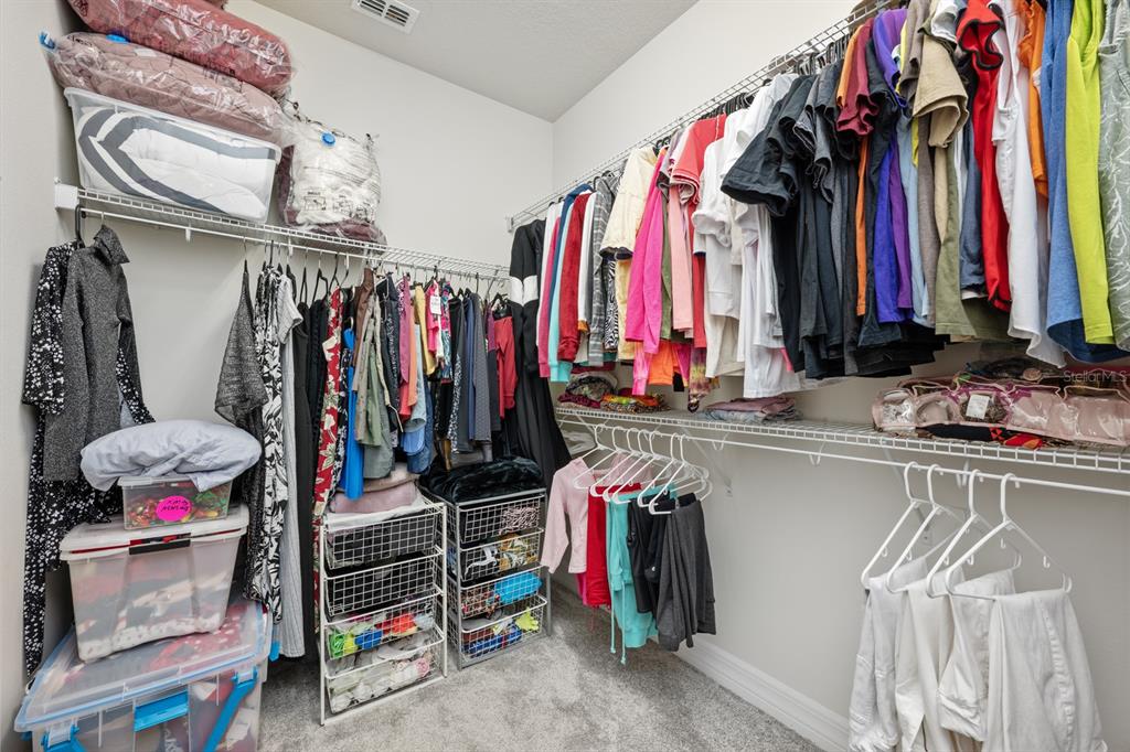 2713 Hilltop Loop Apopka, FL 32712 - Photo 27 of 54 a view of walk in closet with clothes and shoes