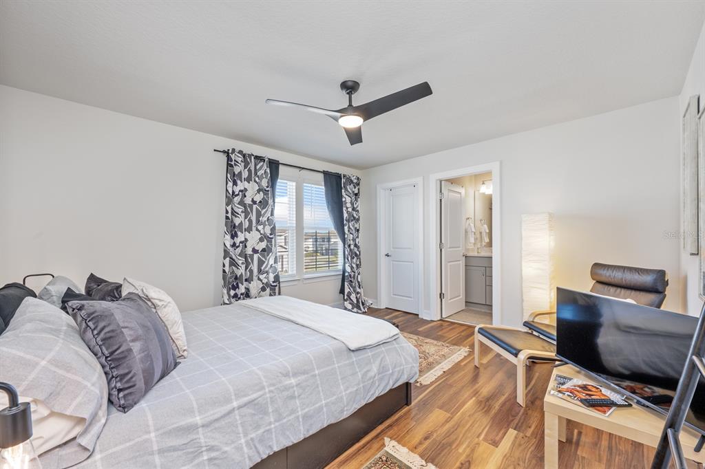 2713 Hilltop Loop Apopka, FL 32712 - Photo 32 of 54 a bedroom with a bed and window