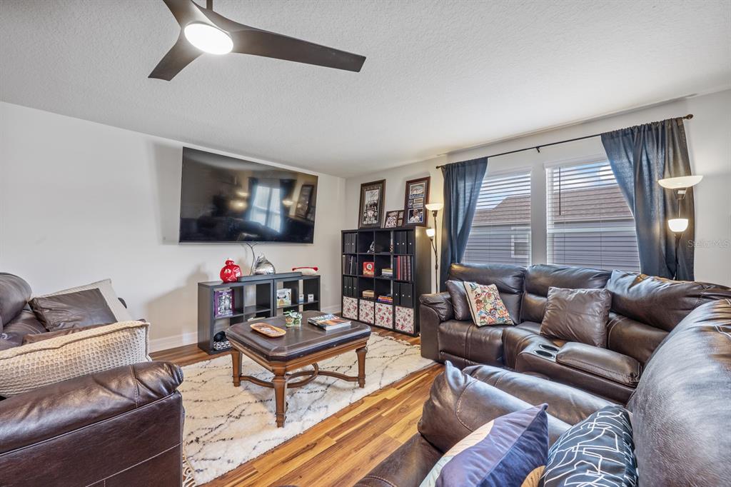 2713 Hilltop Loop Apopka, FL 32712 - Photo 38 of 54 a living room with furniture and a flat screen tv