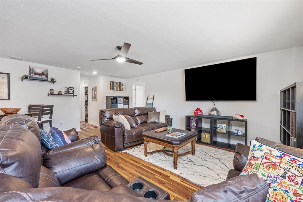 2713 Hilltop Loop Apopka, FL 32712 - Photo 39 of 54 a living room with furniture and a flat screen tv