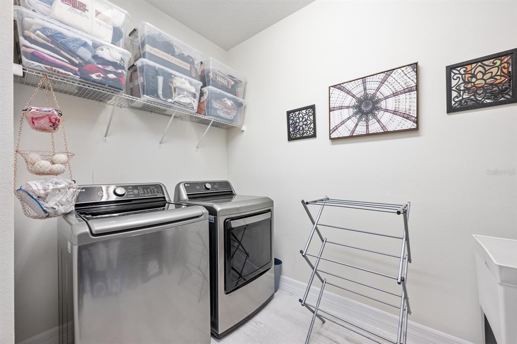 2713 Hilltop Loop Apopka, FL 32712 - Photo 43 of 54 a kitchen with stainless steel appliances granite countertop a stove and a sink with cabinets