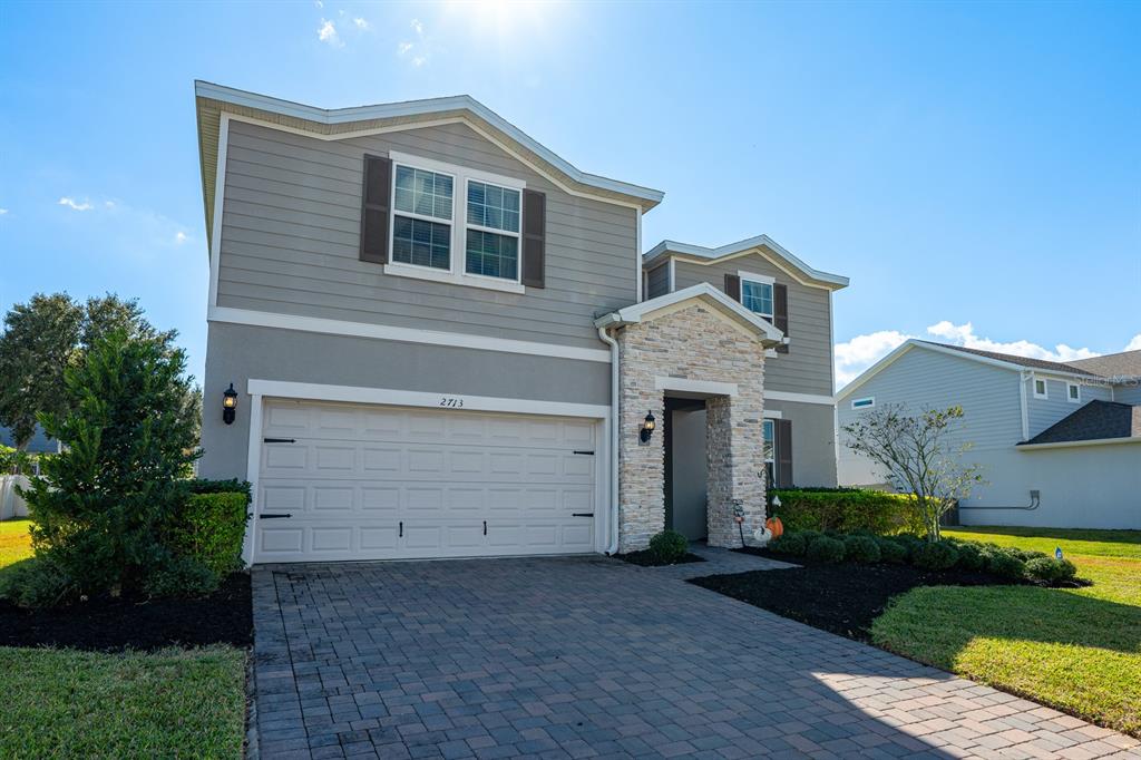 2713 Hilltop Loop Apopka, FL 32712 - Photo 48 of 54 a front view of a house with a yard and garage