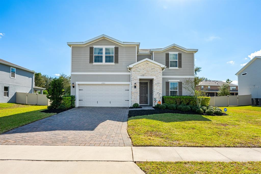 2713 Hilltop Loop Apopka, FL 32712 - Photo 50 of 54 a front view of a house with a yard and garage