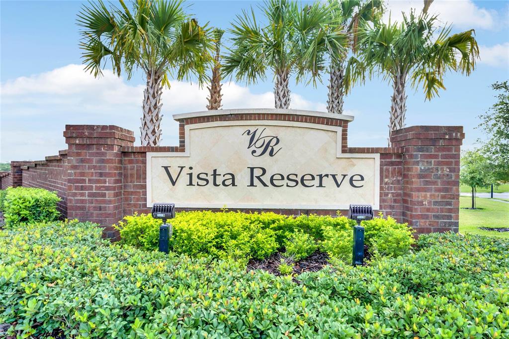 2713 Hilltop Loop Apopka, FL 32712 - Photo 54 of 54 a view of front of house with potted plants and palm trees