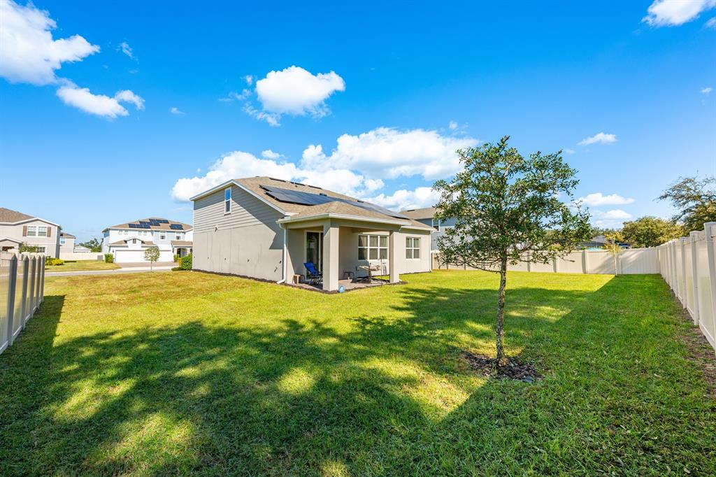 2713 Hilltop Loop Apopka, FL 32712 - Photo 6 of 54 a yellow house with trees in front of it