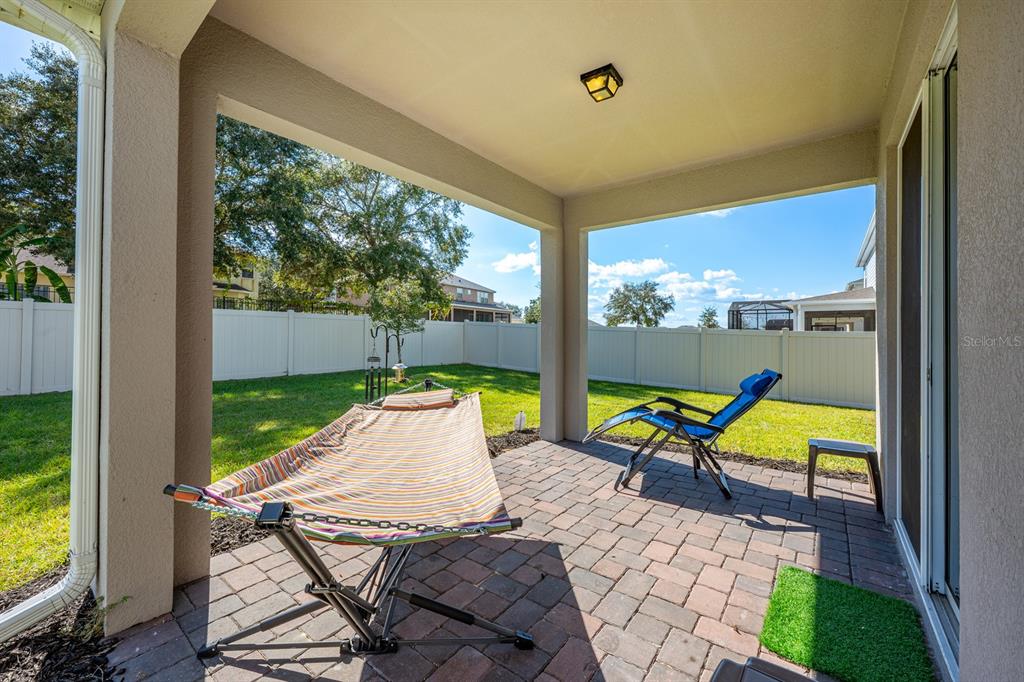 2713 Hilltop Loop Apopka, FL 32712 - Photo 9 of 54 a view of chairs and table in patio with a yard