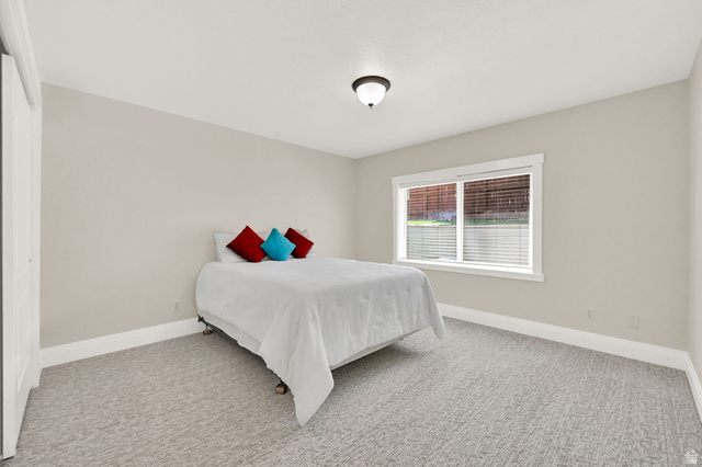 13658 South Fort Street Draper, UT 84020 - Photo 38 of 87 Neutral-toned bedroom featuring patterned carpeting and light beige walls