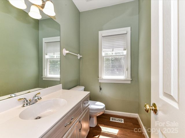 a bathroom with a sink a toilet and mirror