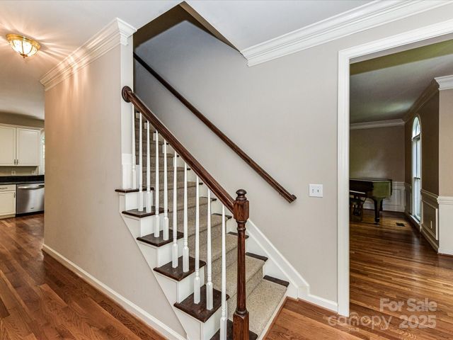 a view of entryway and hall with wooden floor