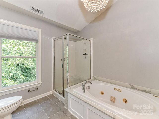 a bathroom with a tub a sink and a shower