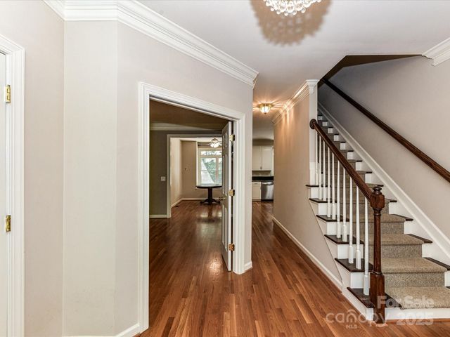a view of a hallway view with wooden floor and staircase