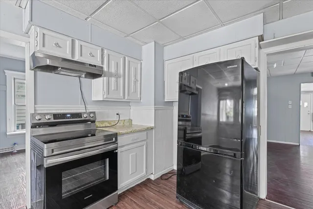 a kitchen with a stove and a refrigerator